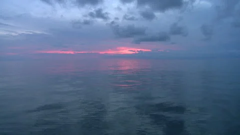 Long shot of the sun setting over the ocean Stock Footage 310539974