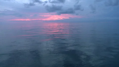 Long shot of the sun setting over the ocean Stock Footage 310539981