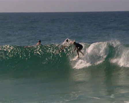 Long shot of surfer surfing progressing into an extreme long shot of the beach i Stock Footage 36645008