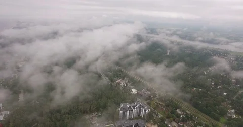 Long shot through clouds of the city with green trees  from the sky. Stock Footage 71623621
