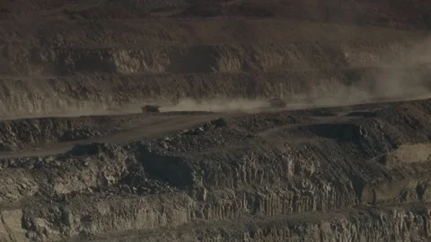 Long shot of two construction vehicles passing each other on opencast mine Stock Footage 312400362