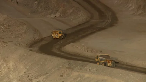 Long shot of two construction vehicles on open cast mine Stock Footage 312400393