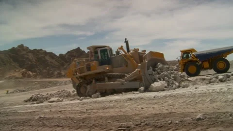 Long shot of two construction vehicles working on a construction site Stock Footage 312400456
