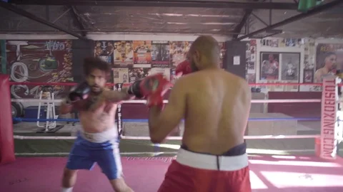 Long Shot of Two Focused, Athletic Men Fighting in Boxing Gym Stock Footage 125284785