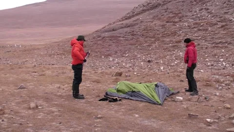 Long Shot of Two Men Assembling Tent Stock Footage 234305893