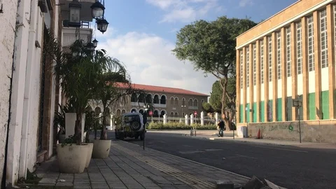Long Shot of Two Men Walking near a Historic Building in Nicosia, Cyprus Видео 101065403