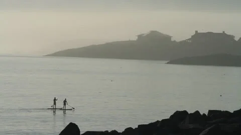 Long shot of two people on paddle boards on the Atlantic, dawn, New England Stock Footage 26891817