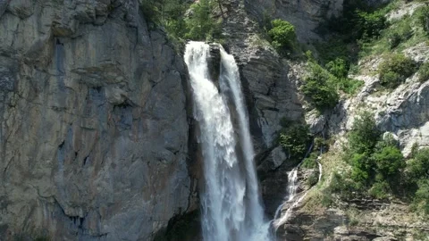 Long shot from a waterfall through the forest to the moutain river Видео 156174335
