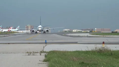 A long shot of a WestJet plane heading to the Runway Stock Footage 79773155
