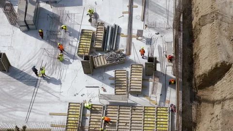 Long shot: Workers doing different tasks at the construction site Stock Footage 236473651