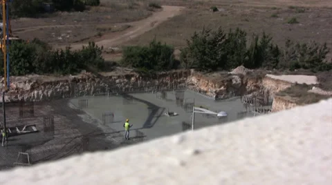 Long shot of workers laying foundations Stock Footage 39859895