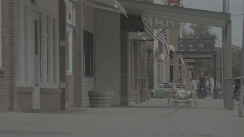 Long Shot of a Young Boy Riding His Bike in a Small Town in Montana Stock Footage 236176830