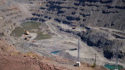Long shot.Top view of the iron ore quarry. A lot of cars work in a career. Stock Footage 116763923