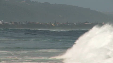 Long side shot of waves rolling in Stock Footage 310385891