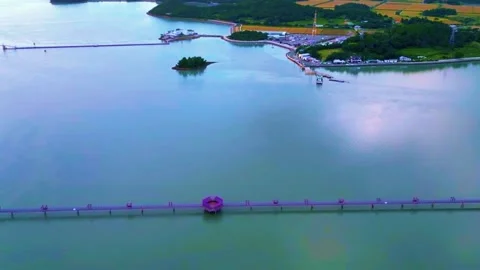 Long Sinuous Purple Pedestrian Bridge over the Yellow Sea Stock Footage 328241675