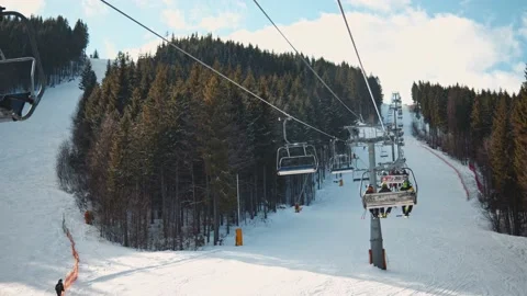 Long ski elevator lifting skiers and snowboarders on top of mountain. Pov shot Stock Footage 148978673