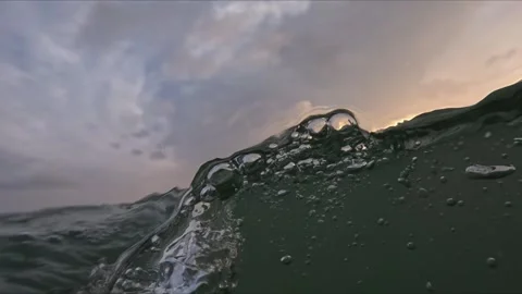 Long slow motion shot of camera diving through sea waves with bubbles dropl.. Stock Footage 344101209