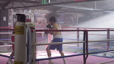 Long Slow Motion Shot of Two Focused, Athletic Men Fighting in Boxing Gym Stock Footage 125284837