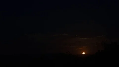 Long slow time lapse of the moon rising over the desert Stock Footage 129967331