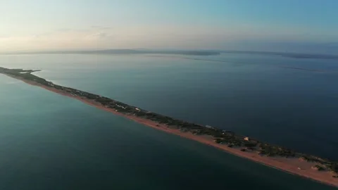 Long spit with sandy beach between sea and liman at sunset, aerial view from Stock Footage 161235476