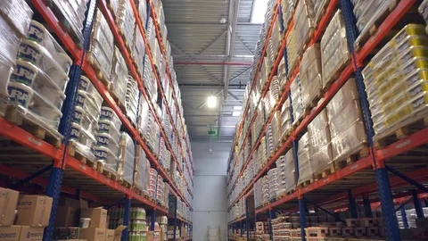 Long storage corridor between rows of shelves with goods Video stock 88761056
