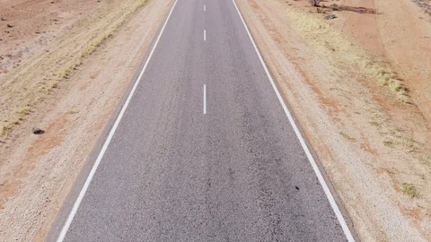 Long straight empty highway in Australian outback. Tilt up Stock Footage 120141015