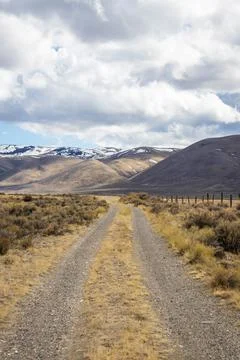 A long, straight road heading into the distant mountains Photos