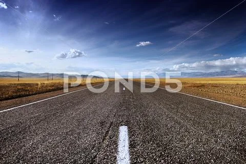 Long straight road mountains concept Stock Photos