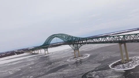 Long straight winter bridge with moving traffic aerial Stock Footage 329395633