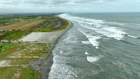 Long Surf Beach Coastline with Waves Rolling Toward Tropical Shoreline Stock Footage 342819879
