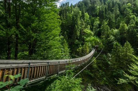 Long suspension bridge in the mountains while hiking Stock Photos