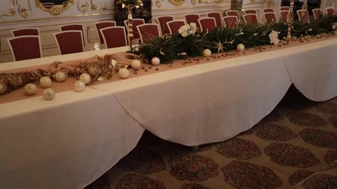 A long table adorned with elegant decorations including golden ornaments, white  Stock Footage 294771593