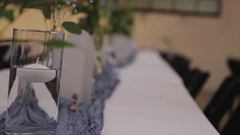 Long Table with Blue Runner and Floral Decor in Soft Light Stock Footage 336804460