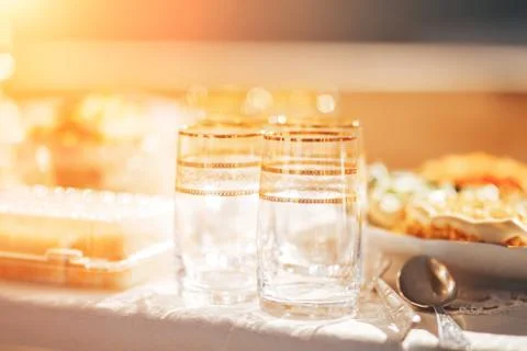 Long table covered with a tablecloth on which there is a lot of food, food in Stock Photos