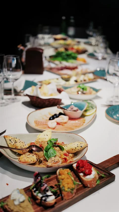 A long table laden with a variety of delicious dishes and appetizers awaits.. Stock Footage 339442313