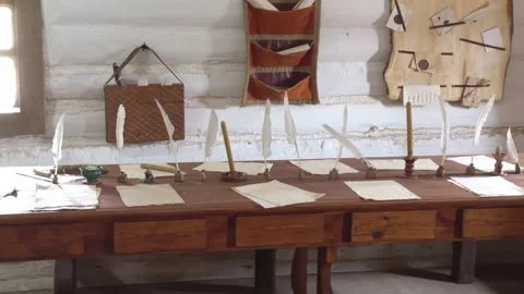 Long table with quills and scrolls in the interior of a historical scriptor.. Stock Footage 332399655