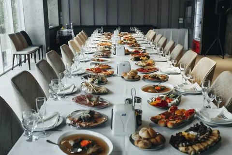 Long table set for a formal dinner gathering Fotos de archivo