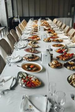 Long table set for a formal gathering Foto stock