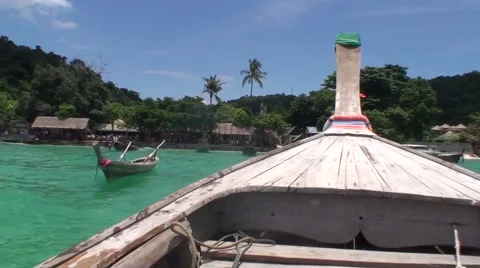 Long tail boat approaching to the coast of Phi Phi Island Stock Footage 68710149