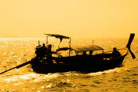 Long tail boat float on the sea over the sunset, Krabi, Thailand Stock Photos