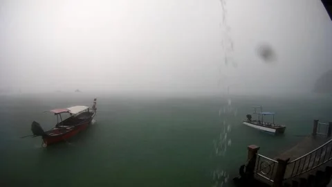 Long tail boat floating in the sea while raining, Phuket, Thailand2 Vídeo Stock 248039059