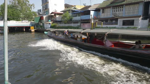 Long-Tail Boat Speeding Through Urban Canal in Thailand Stock Footage 323428659