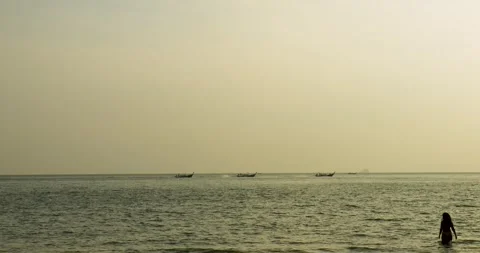 Long tail boats navigating in the sunset near Railay beach Stock Footage 303749005