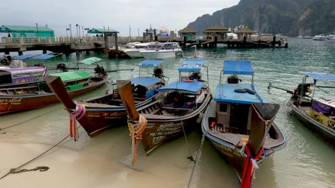 Long tail boats at Phi Phi Don harbor - nearest place for daily trip to Maya Stock Footage 194847121