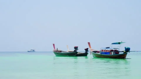 Long-tailed boat is floating on the emerald sea at Koh Lipe, Thailand. Stock Footage 138302492