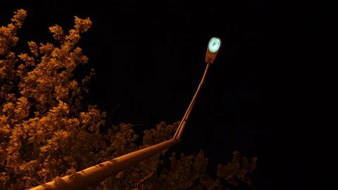 Long take of a creepy street light flickering on over the course of a Stock Footage