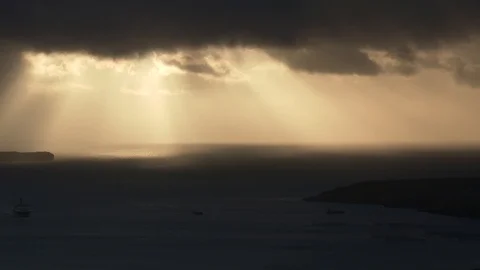 Long take of rays of sun light shining from above moving clouds to the sea Stock Footage 92642899