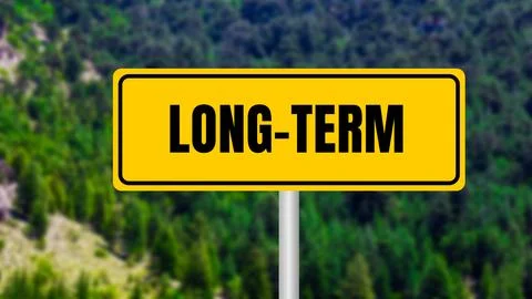 Long term message written on yellow metal sign  on nature background. Concept Stock Photos