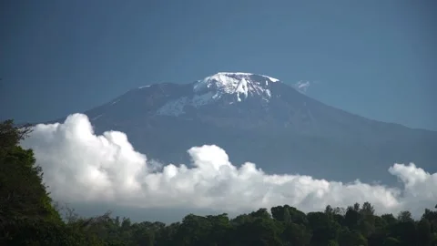 Long time lapse of white clouds move below majestic Kilimanjaro snowy mountain Stock Footage 204132107