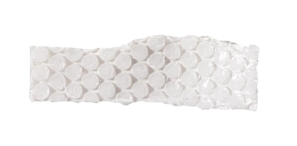 A long torn strip of bubble wrap with repeating circular cells and crumpled Stock Photos